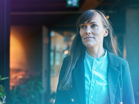Woman in a hallway at a company.