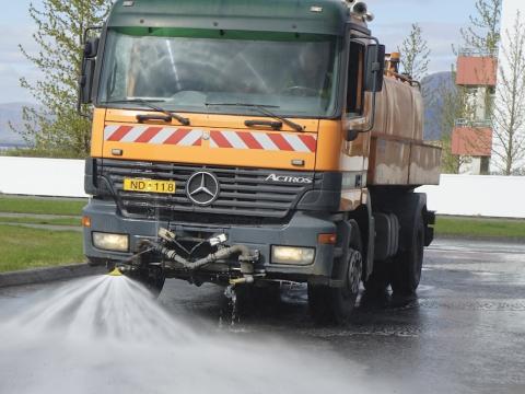 Large street sweeping and washing machine at work