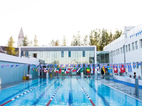 Sundhöll Reykjavík Pool, outdoor area, looking across the deep pool toward the building.