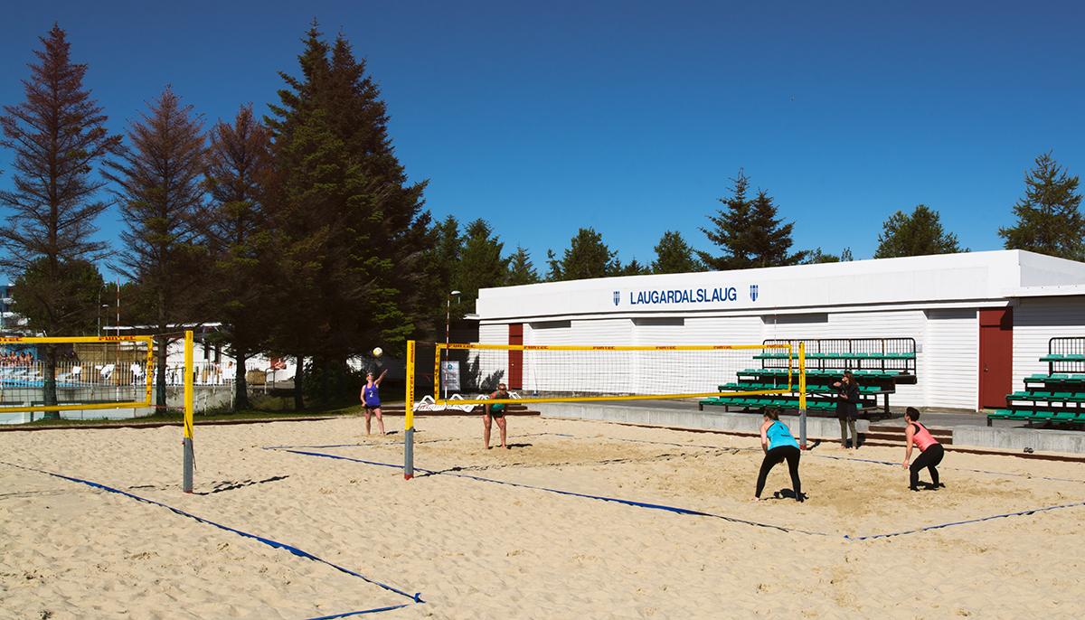 Four women playing beach volleyball on one of the beach volleyball courts at Laugardalslaug Pool