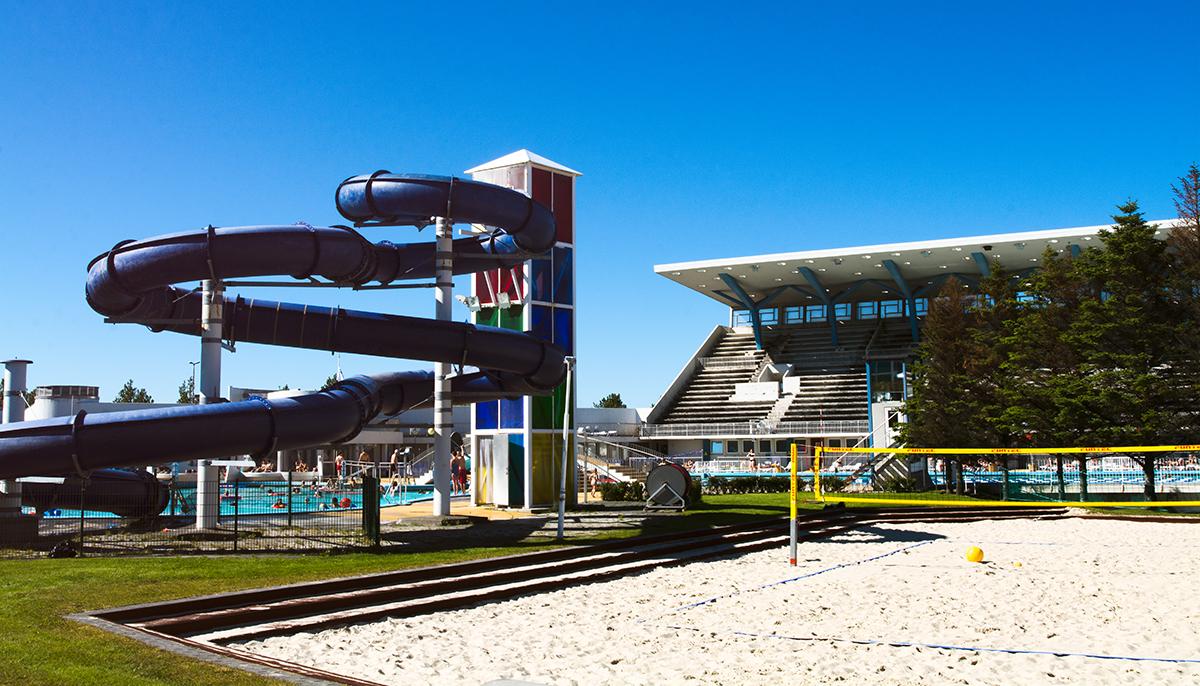 Beach volleyball court, large slide and grandstand at Laugardalslaug Pool