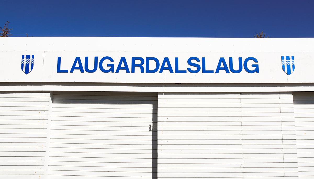 Laugardalslaug Pool sign and Reykjavík City logo on poolside storage sheds