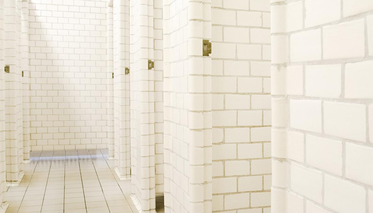 Original individual stalls in the men's changing room at Sundhöll Reykjavík Pool