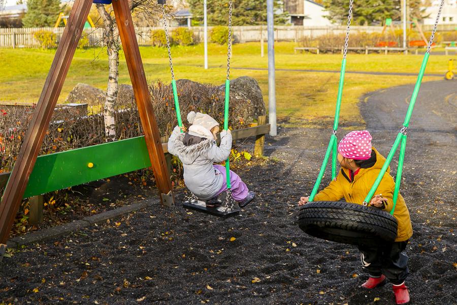 Children swing on Holt's grounds.