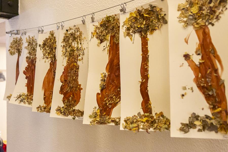 Children's artwork hangs on a wall inside Rofaborg.