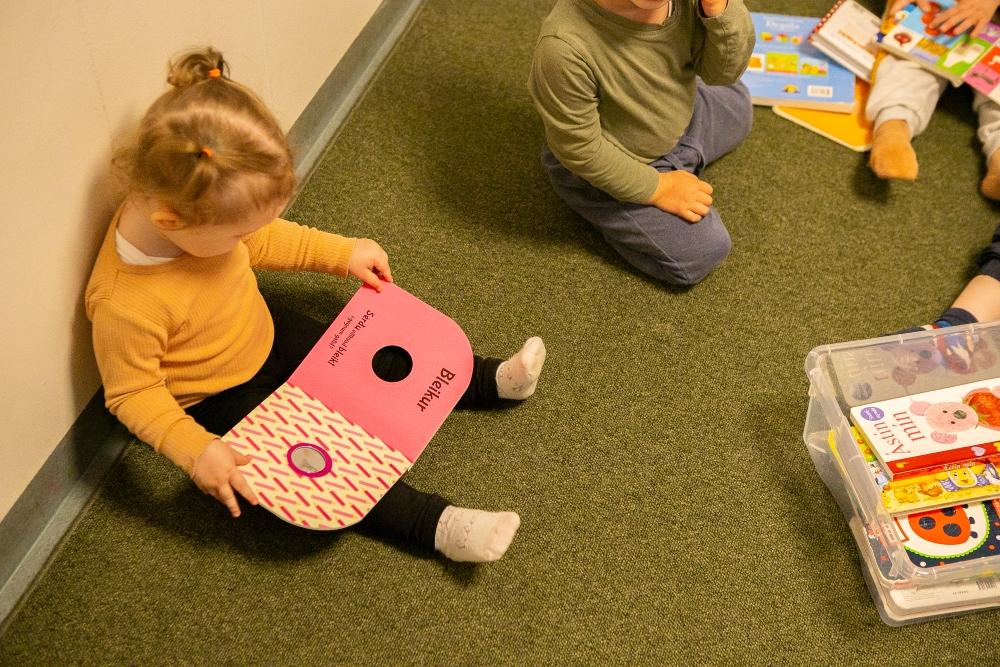 Children sitting on the floor reading books