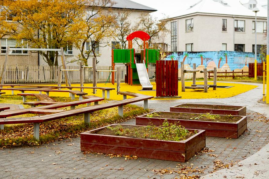 Planter boxes and slide in the outdoor area at Hlíðar preschool at Engihlíð