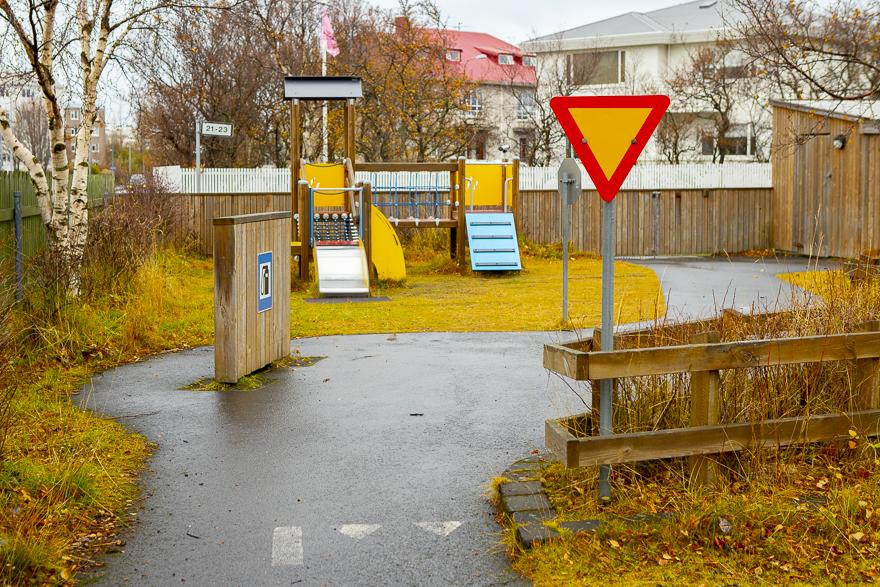 Traffic signs, play gas station and slides in the outdoor play area at Hlíðar preschool, Eskihlíð