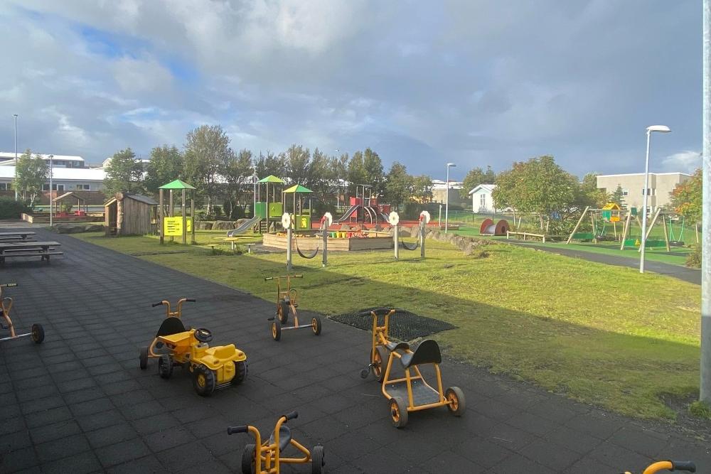 Overview of Nes preschool's outdoor area with tricycle in the foreground