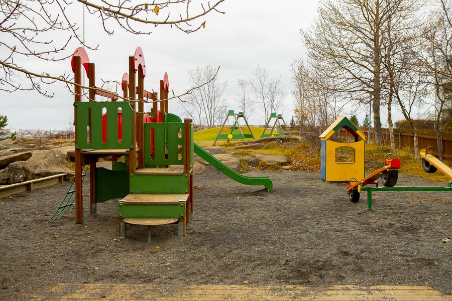 Play castle with slide and small house on the outdoor grounds at Sunnufold preschool
