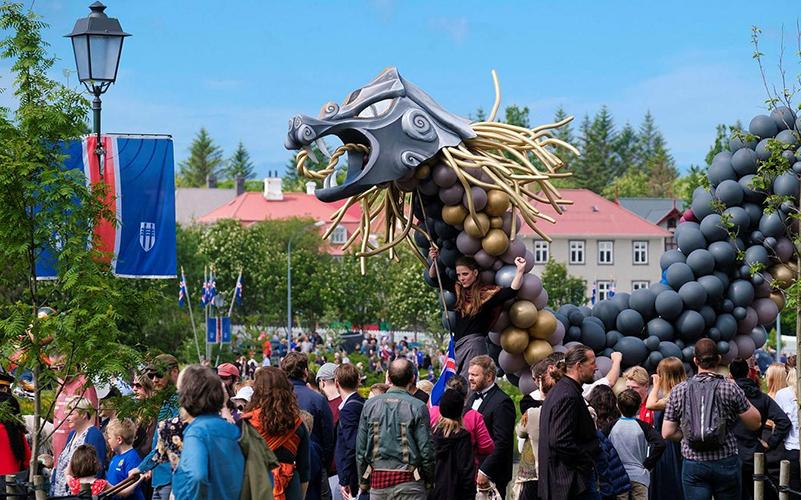 People and a giant dragon in the parade on June 17th.