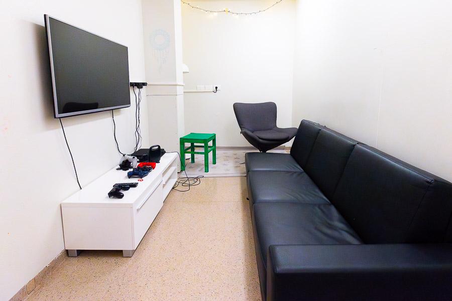 Black sofa and television on the wall. 