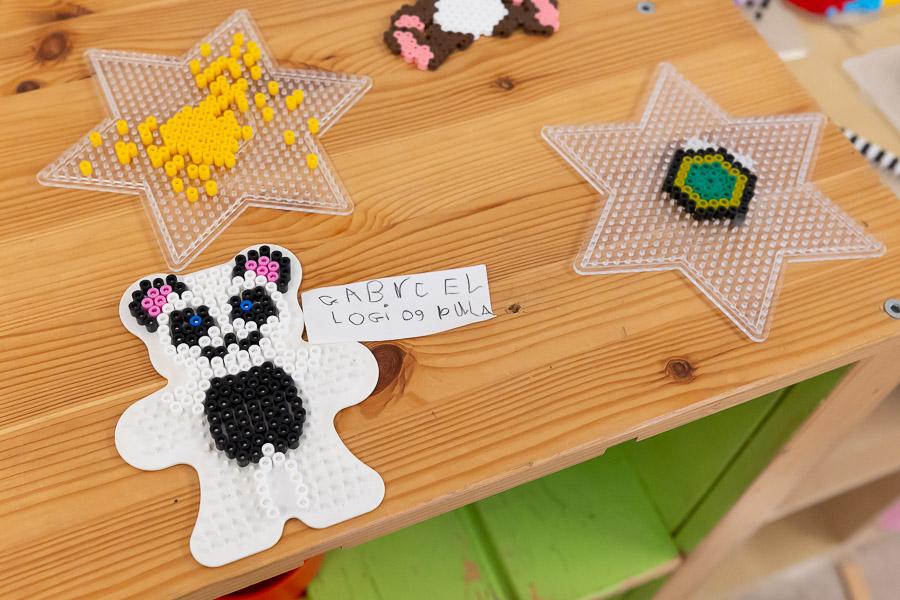 Bear made from Perler beads and star-shaped beading forms.