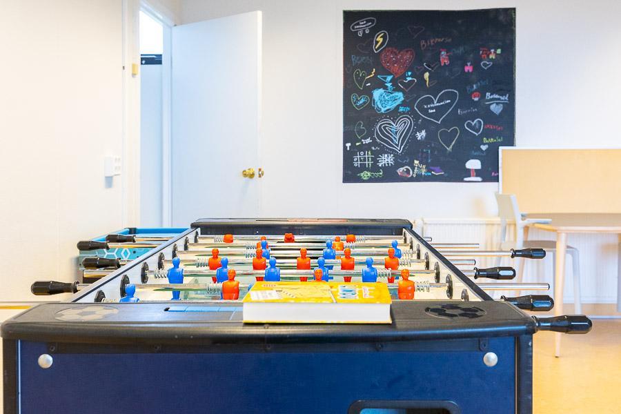 Foosball game and chalkboard with hearts in the background. 