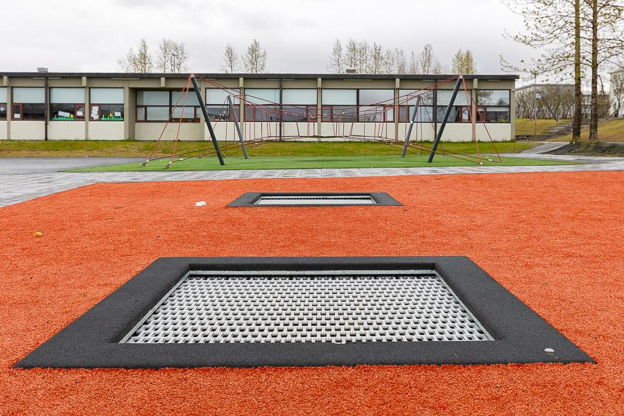 Trampoline on red surface. 
