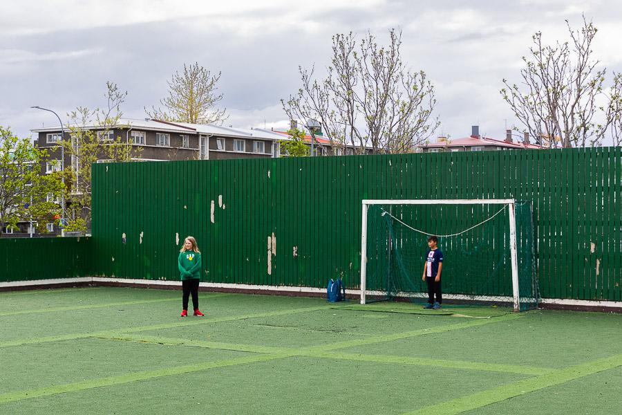 Two children on a soccer field at the Draumaland after-school program.