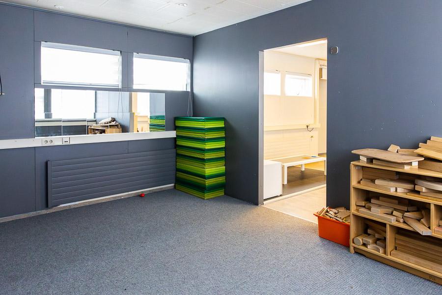 A room with cushions and large wooden blocks.