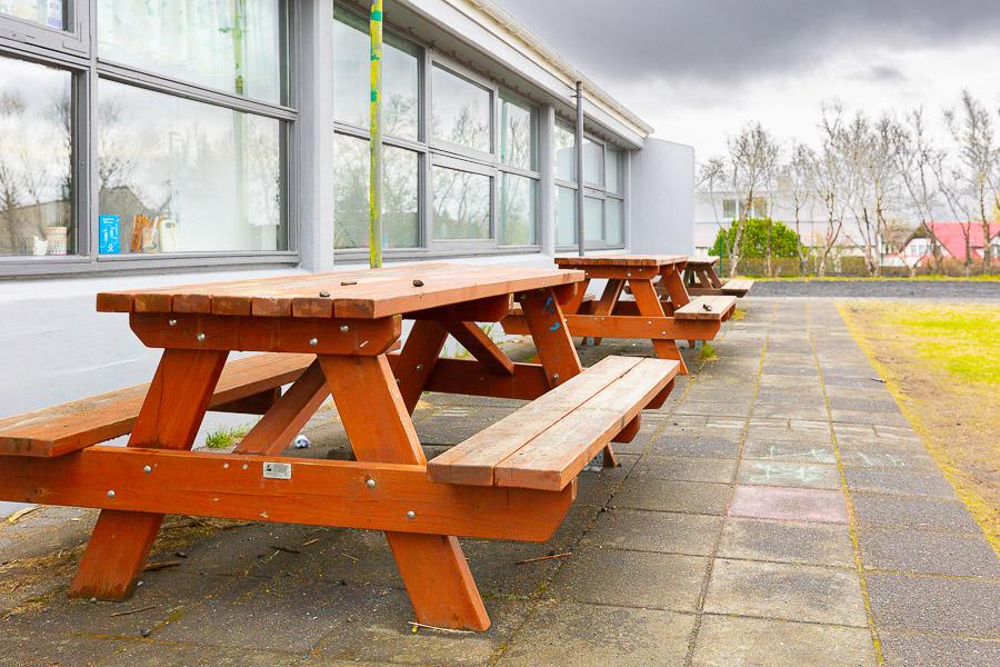 Outdoor benches and tables on school playground.