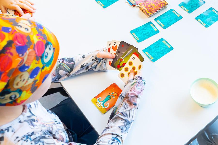 A child sits at a table playing.
