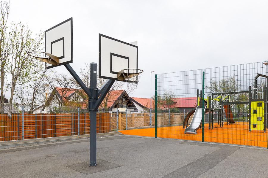 Basketball court and playground castle in the background.