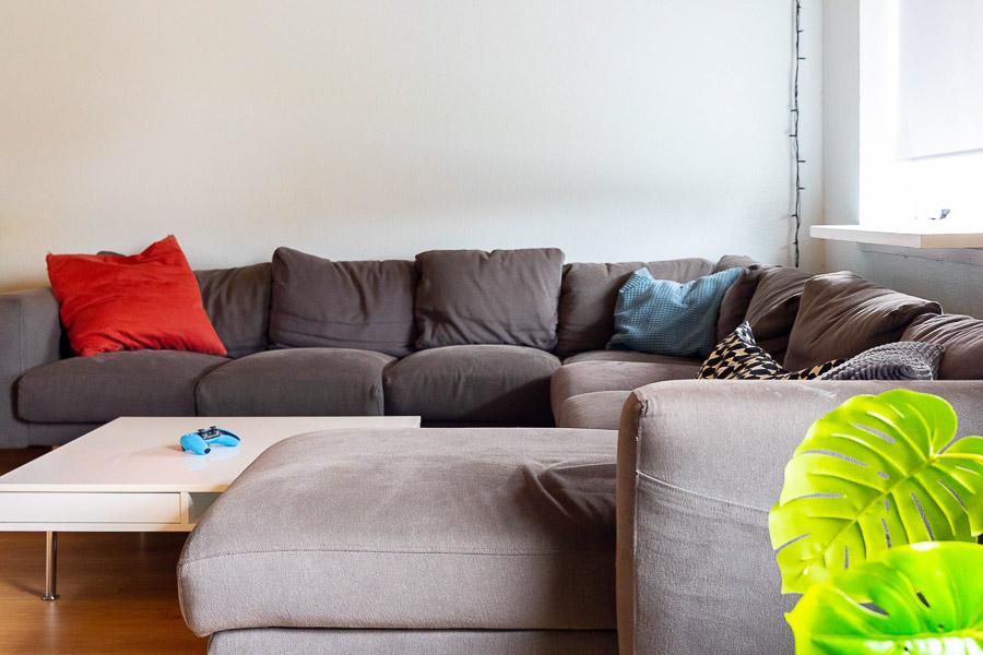 A gray corner couch and a coffee table. 