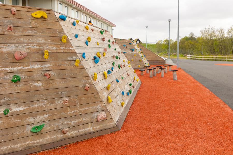 Climbing walls on a red playground.