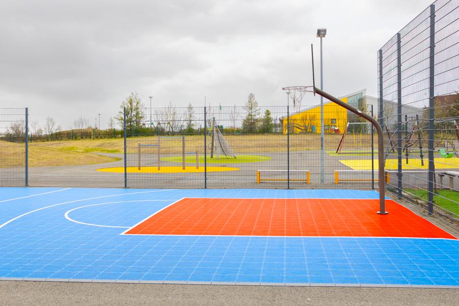 A fenced-in basketball court.