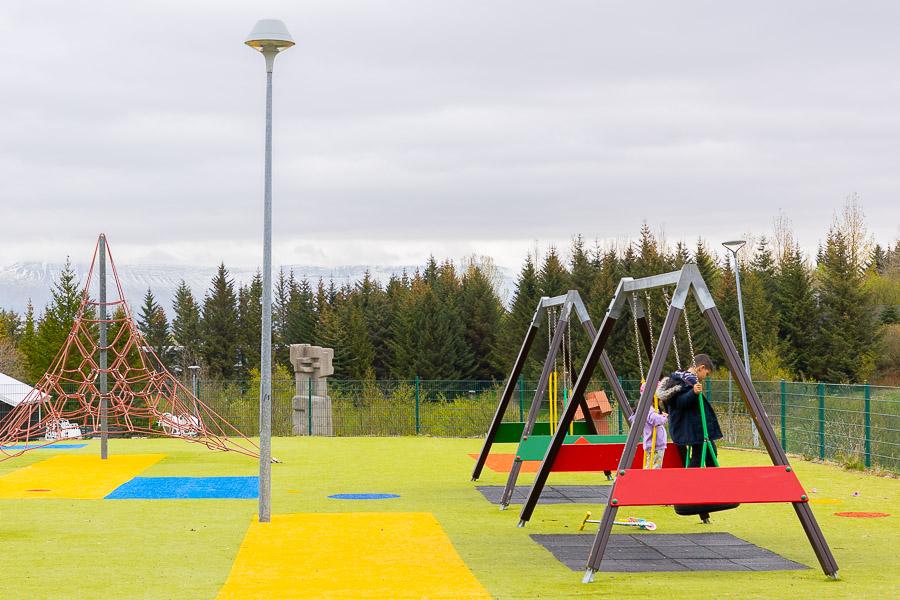 Colorful playground with jungle gym and swings.