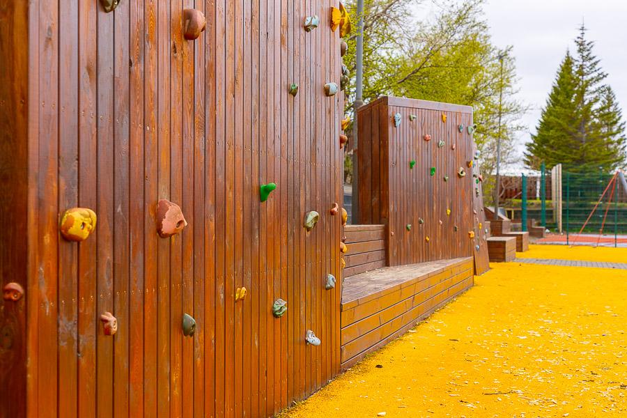 Brown climbing walls on a yellow playground.