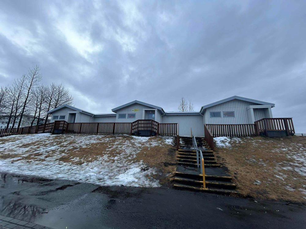 Bakkasel Recreation Center buildings on a hill. Steps leading up to the building with grass to the side. 