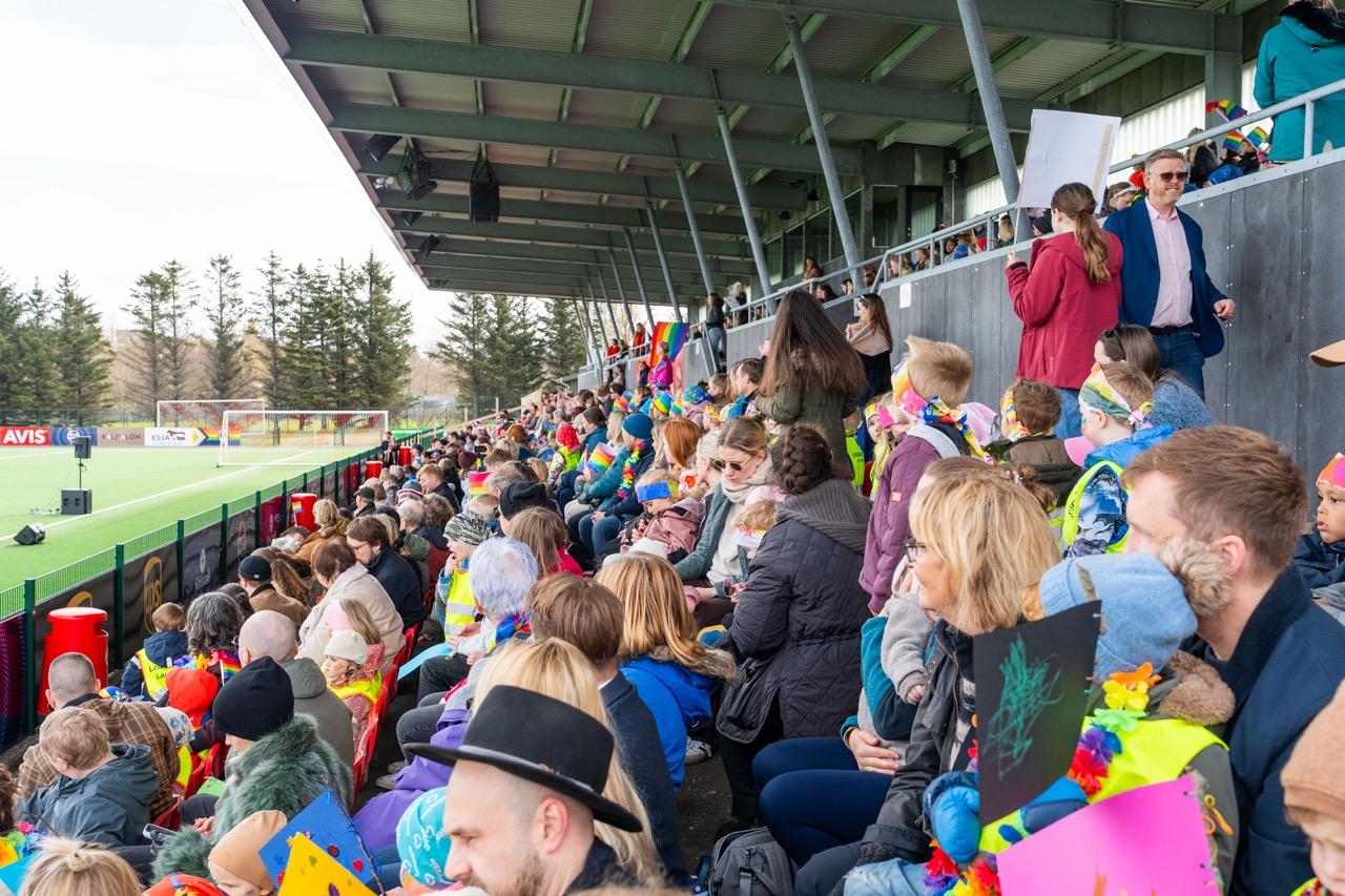 A view from the grandstand at Þróttarvöllur. Filled with children and families.