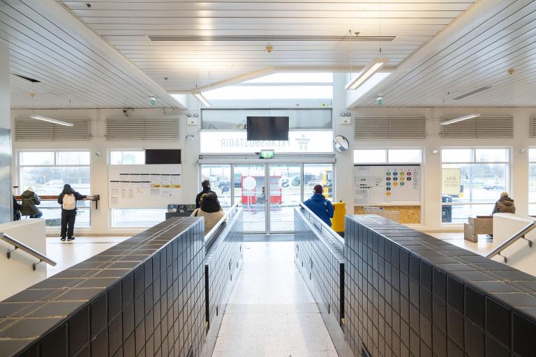Inside the Mjódd bus station, looking down the walkway toward the entrance