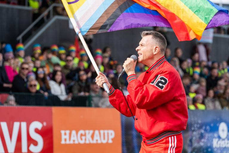 Páll Óskar holding the Rainbow Flag.