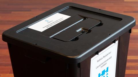 Ballot box. Black ballot box with labels reading "City Hall — early ballots received at the municipal office."